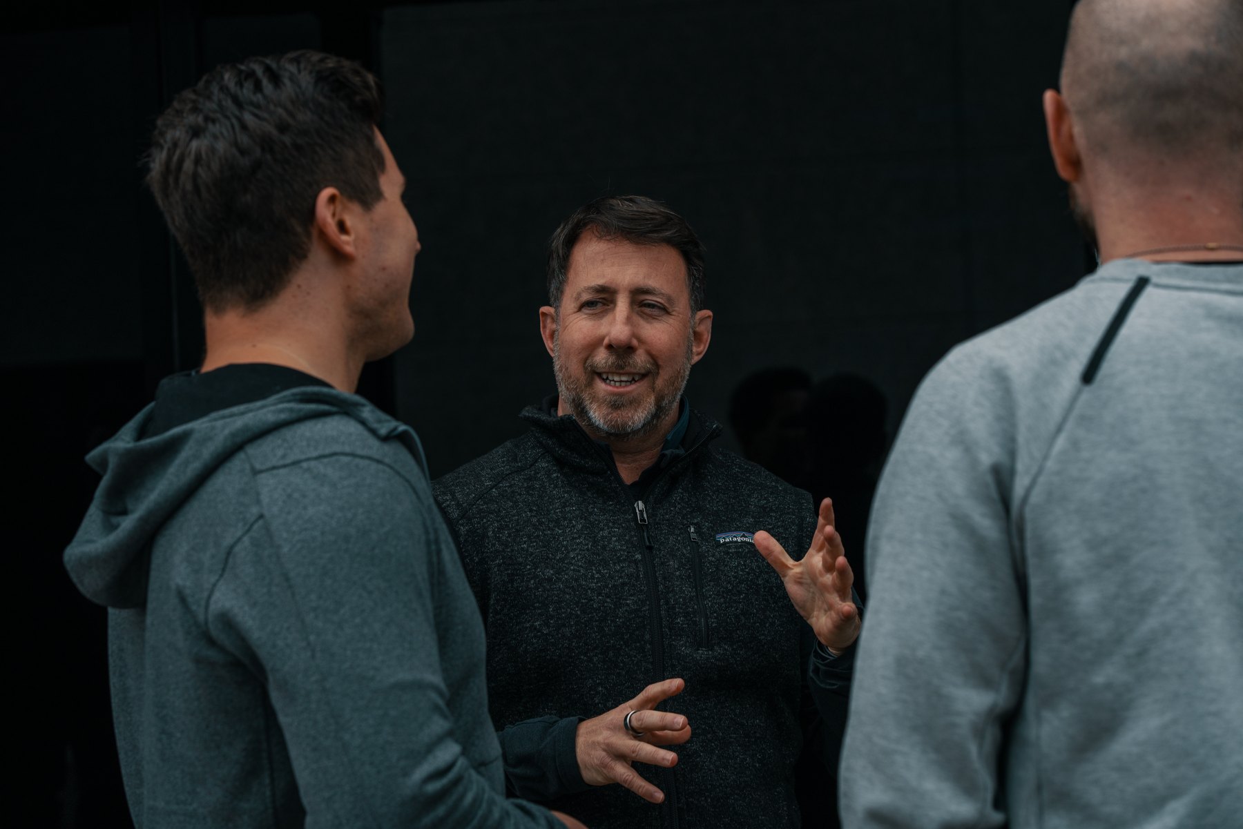 Michael Kimelman in conversation with two younger men